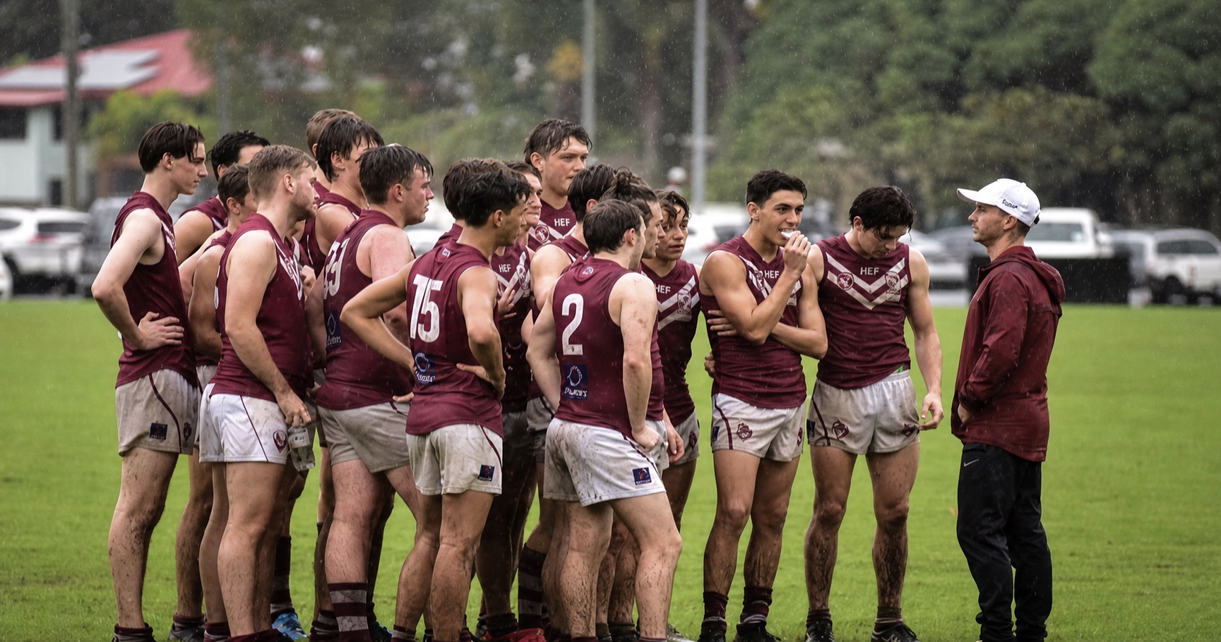 Kyle coaching a football team together in the rain